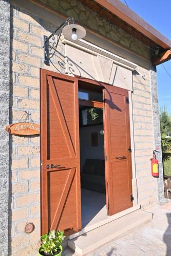 an open door into a shed with a couch inside at Agriturismo le Fontane - Lago di Bolsena in Grotte di Castro