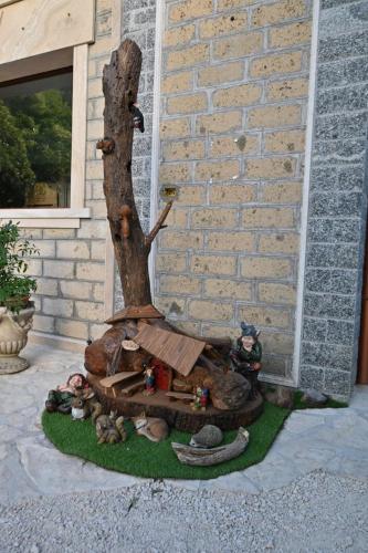 a statue of a tree with people around it at Agriturismo le Fontane - Lago di Bolsena in Grotte di Castro