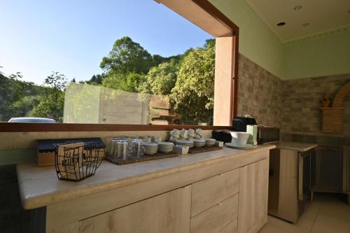 a kitchen with a counter with dishes on it at Agriturismo le Fontane - Lago di Bolsena in Grotte di Castro