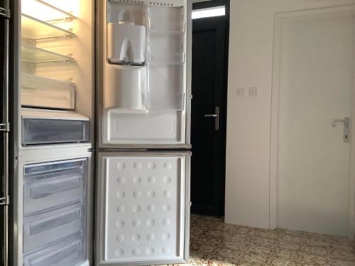 an empty refrigerator with its door open in a room at Rooms 22 - Beachfront in Primošten