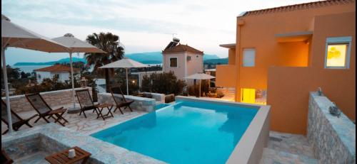 a swimming pool on the side of a house at Dimani Suites in Gythio