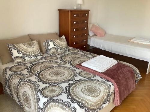 a bedroom with two beds and a dresser in it at Rooms 22 - Beachfront in Primošten