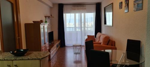 a living room with a couch and a glass table at Apartamentos Florazar II in Cullera