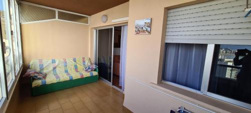 a living room with a chair and a window at Apartamentos Florazar II in Cullera