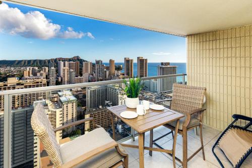 a balcony with a table and chairs and a view of the city at Ocean & Diamond Head View Studio at Waikiki in Honolulu