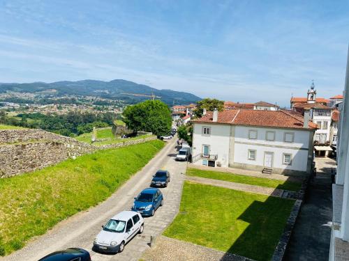 a group of cars parked on a street next to a building at Residencial Portas do Sol in Valença