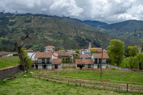 a village with a mountain in the background at La Posada Campestre Cabañas in El Cocuy