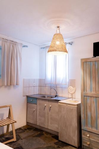 a kitchen with a sink and a window at Anna's Apartments in Mikonos