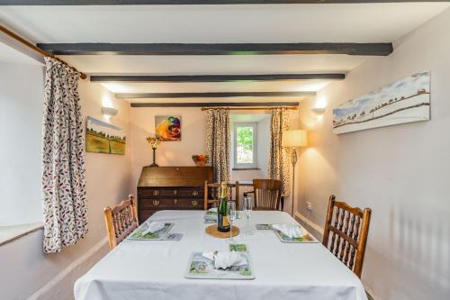 a dining room with a table and chairs at Old Dame School in Bainbridge