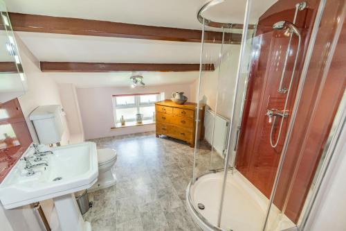 a bathroom with a shower and a sink and a toilet at Old Dame School in Bainbridge