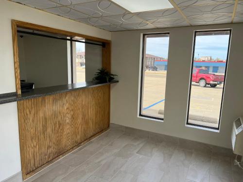 an empty office with a counter and windows at Dickinson Inn in Dickinson