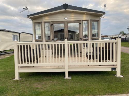 a gazebo with a white fence on the grass at The Windermere in Whitstable
