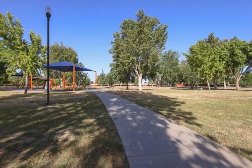 a walkway in a park with a playground at Private Pool and Patio Pet-Friendly Bakersfield Gem in Bakersfield