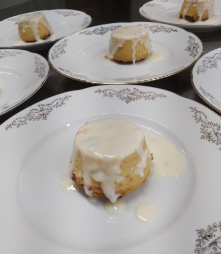 a piece of cake on a plate with icing at Moon Garden in Mongardino