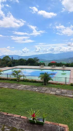 a large swimming pool in the middle of a yard at Hotel Campestre Las Marias- El Colegio in El Colegio