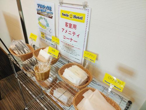 a shopping cart filled with baskets of cheese at Smile Hotel Tokyo Tamanagayama in Tama