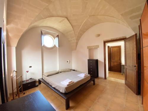 a bedroom with a bed in a room with a ceiling at Comfortable House with Fenced Garden - Surano - Fireplace in Surano
