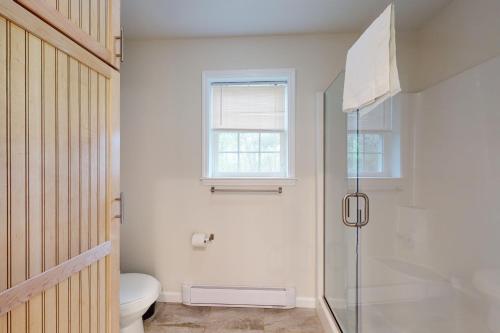 a bathroom with a shower and a toilet and a window at Oak Bluffs Beauty in Oak Bluffs