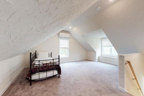 a attic room with a bed in the middle at Oak Bluffs Beauty in Oak Bluffs