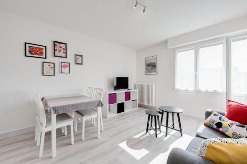 un salon blanc avec une table et des chaises dans l'établissement Les Cloches - Charmant T2 proche du Lac, à Annecy