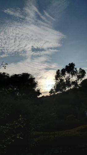 a view of a sky with trees in a field at Casa Agradável com piscina. in Miguel Pereira