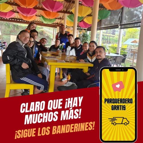 a group of people sitting at a table with a sign at Villa Paulina in Guadalupe