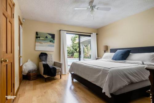 a bedroom with a bed and a window at Cozy Hygge Home Centrally Located 2 King Beds in Bakersfield