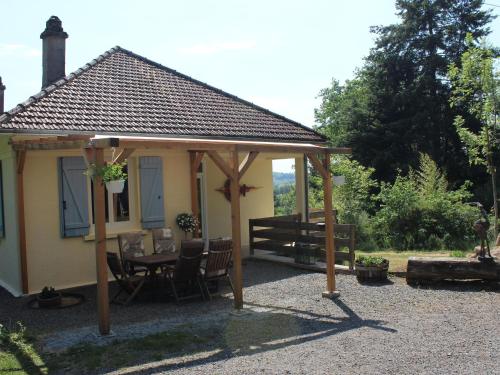 a gazebo with a table and chairs in a yard at Attractive holiday home in Cuzy with pool in Cuzy