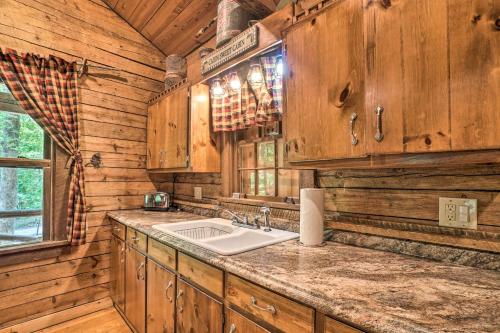 eine Küche mit einem Waschbecken und Holzwänden in der Unterkunft North Georgia Mtn Escape with Fire Pit and Grill! in Sautee Nacoochee
