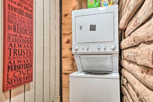 a white stove in a room next to a stone wall at North Georgia Mtn Escape with Hot Tub and Games! in Sautee Nacoochee