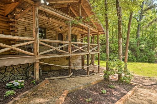 a log cabin in the middle of a forest at North Georgia Mtn Escape with Hot Tub and Games! in Sautee Nacoochee