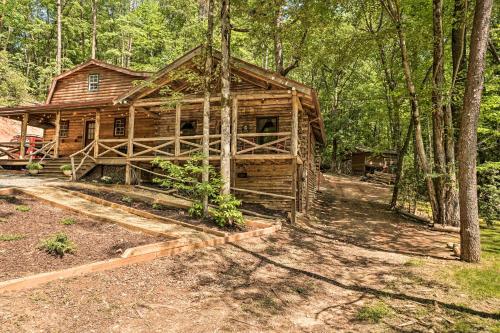 a log cabin in the middle of the woods at North Georgia Mtn Escape with Hot Tub and Games! in Sautee Nacoochee