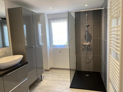 a bathroom with a glass shower and a sink at Gîte Montaiguët-en-Forez, 5 pièces, 8 personnes - FR-1-489-371 in Montaigüet-en-Forez