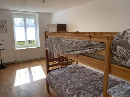 a room with two bunk beds and a window at Gîte Montaiguët-en-Forez, 5 pièces, 8 personnes - FR-1-489-371 in Montaigüet-en-Forez