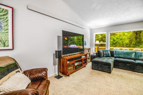 a living room with a couch and a tv at Netarts Getaway in Tillamook