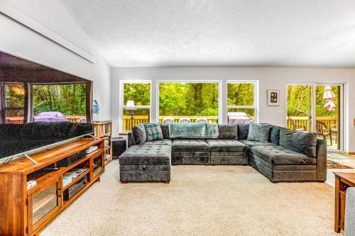 a living room with a couch and a table at Netarts Getaway in Tillamook