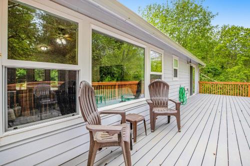 a porch with two chairs and a table on it at Netarts Getaway in Tillamook