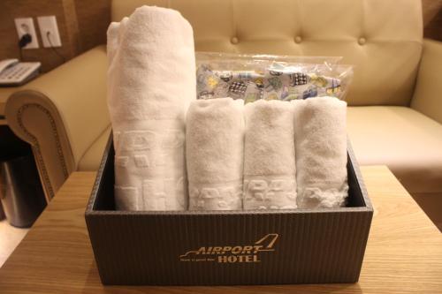 a box of towels on a table in a hotel room at Hotel Airport in Busan
