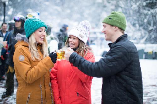 a group of people standing in the snow at Thredbo Alpine Hotel in Thredbo