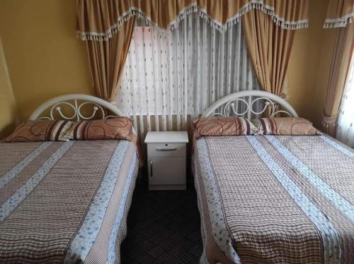 Postel nebo postele na pokoji v ubytování Hostal Flores