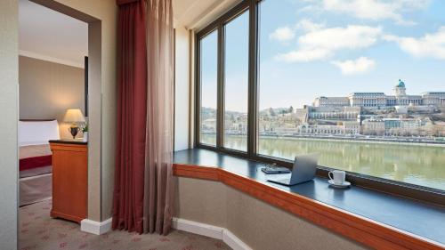 a room with a window with a laptop on a desk at InterContinental Budapest by IHG in Budapest