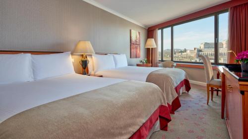 a hotel room with two beds and a window at InterContinental Budapest by IHG in Budapest