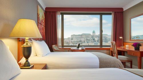 a hotel room with two beds and a window at InterContinental Budapest by IHG in Budapest