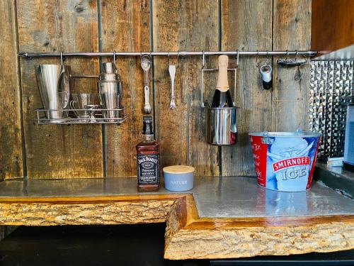 a wooden counter with utensils on a wooden wall at Artemis Log Cabin with Spa & Mountain View in Sainte-Lucie-de-Doncaster