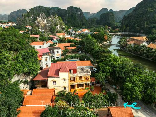 a view of a town with a river and mountains at Tam Coc Mountain Lake Homestay in Ninh Binh