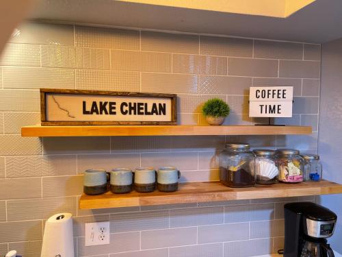 a shelf in a kitchen with jars on it at Next to Lake, Pool, 10 Acre Park, 1 Mile to Town, Best Prices in Chelan