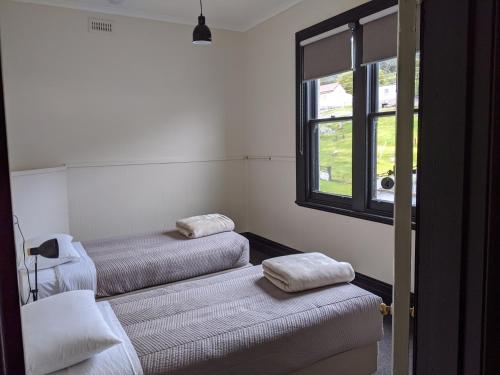 two beds in a room with a window at The Dorset Hotel in Derby