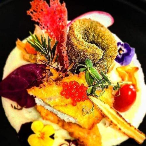 a plate of food with vegetables and fruit on it at La Konac in Murighiol
