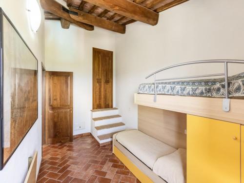 a room with a bunk bed and a staircase at Luxurious Holiday Home with Hill view in Asciano Tuscany in Asciano