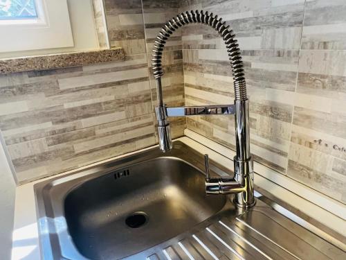 a kitchen sink with a chrome faucet at Villa Amedea in Lignano Sabbiadoro